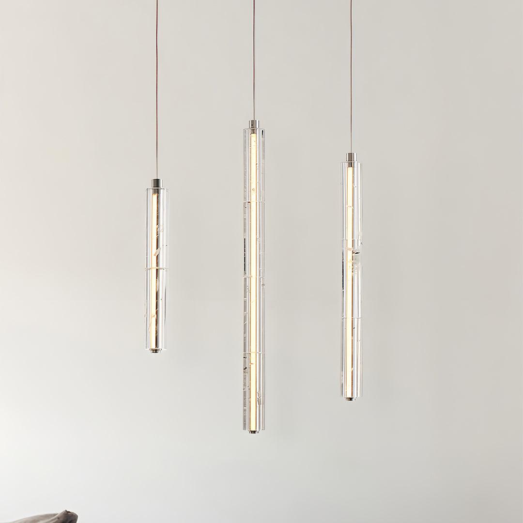 Three Aureon crystal pendant lights aligned vertically in a contemporary modern interior