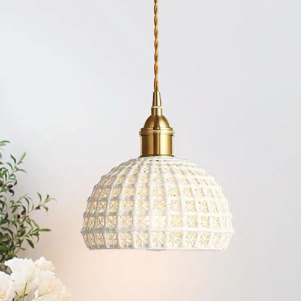 Aureon ceramic pendant light in blue shade with copper brass frame against a neutral interior