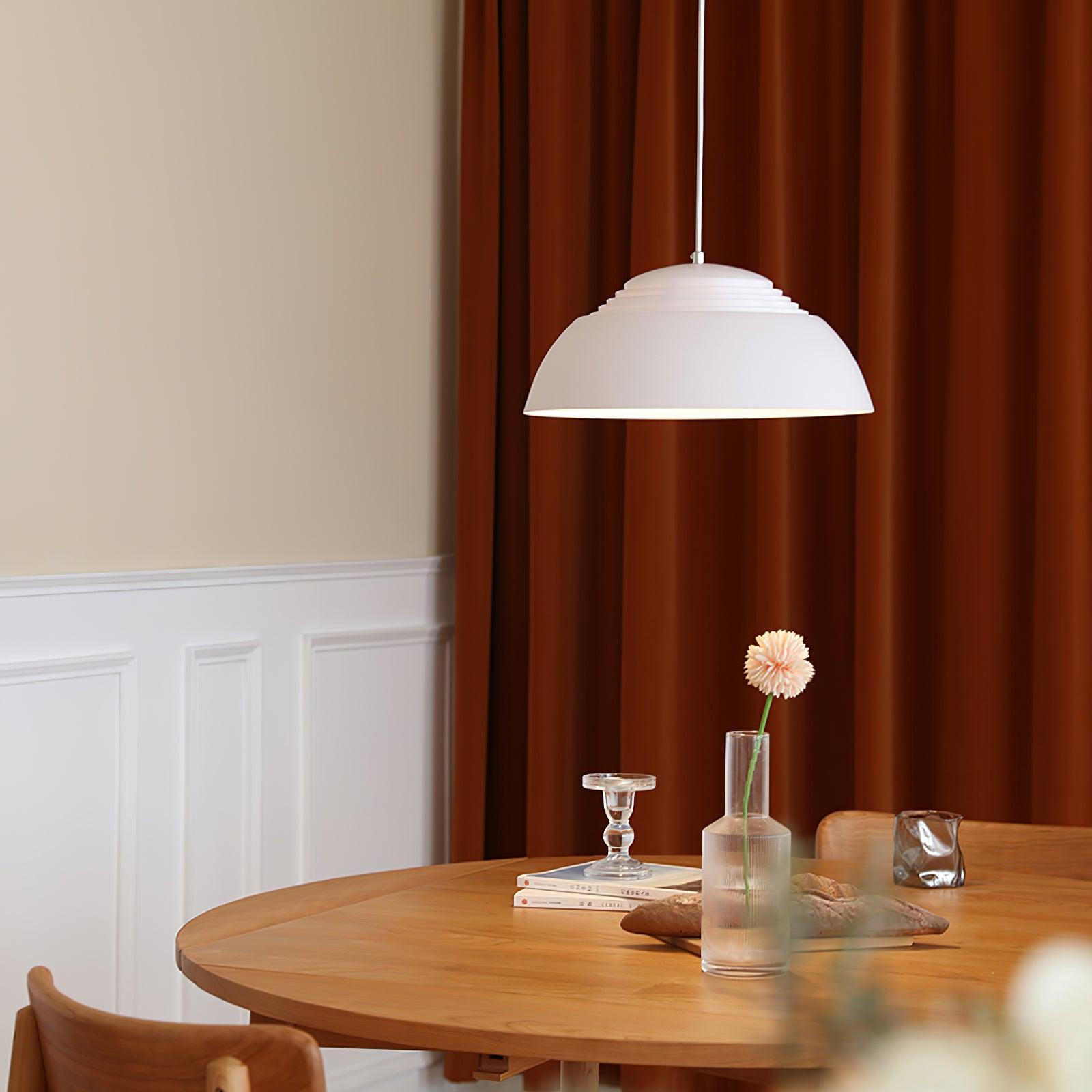 Vantara drum pendant in matte white in a contemporary living room with neutral tones