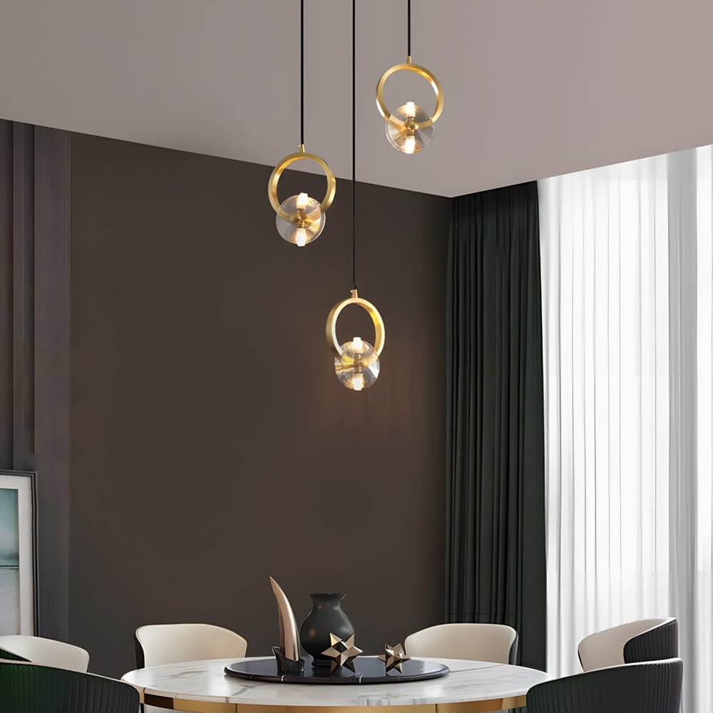1-light copper crystal pendant light hanging above a bar counter in a modern interior
