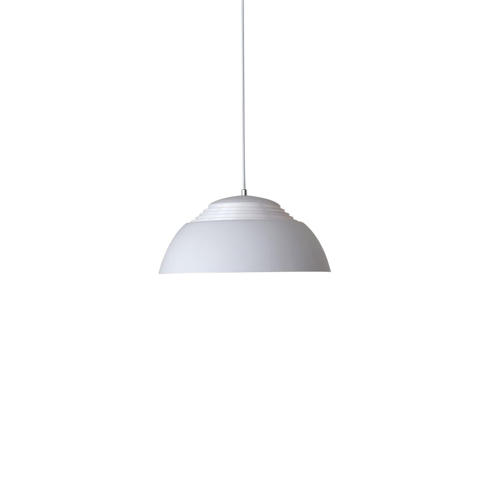 Vantara aluminium pendant light in matte black hanging above a kitchen island in a contemporary kitchen