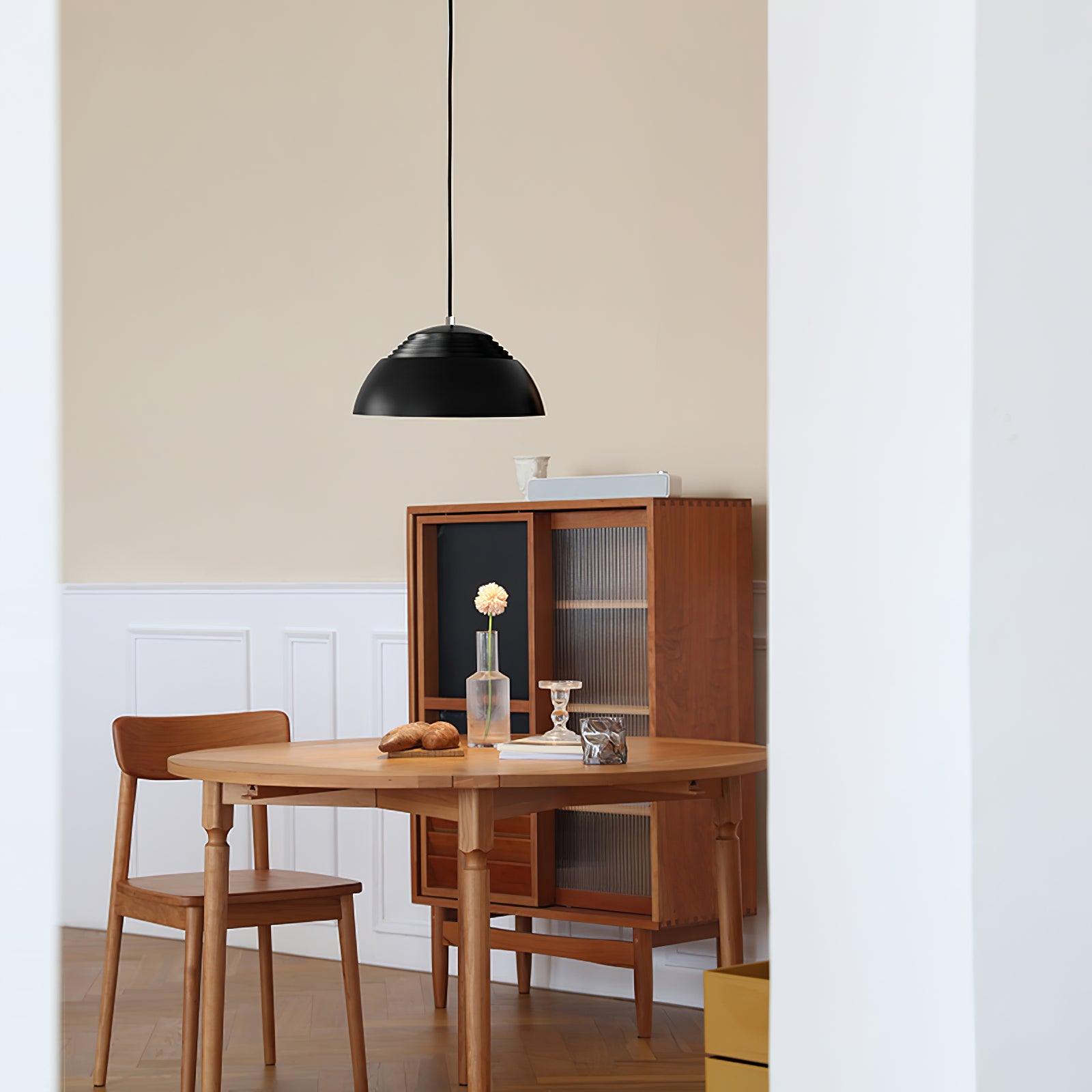 Vantara ridged pendant in matte white above a round dining table in a contemporary apartment