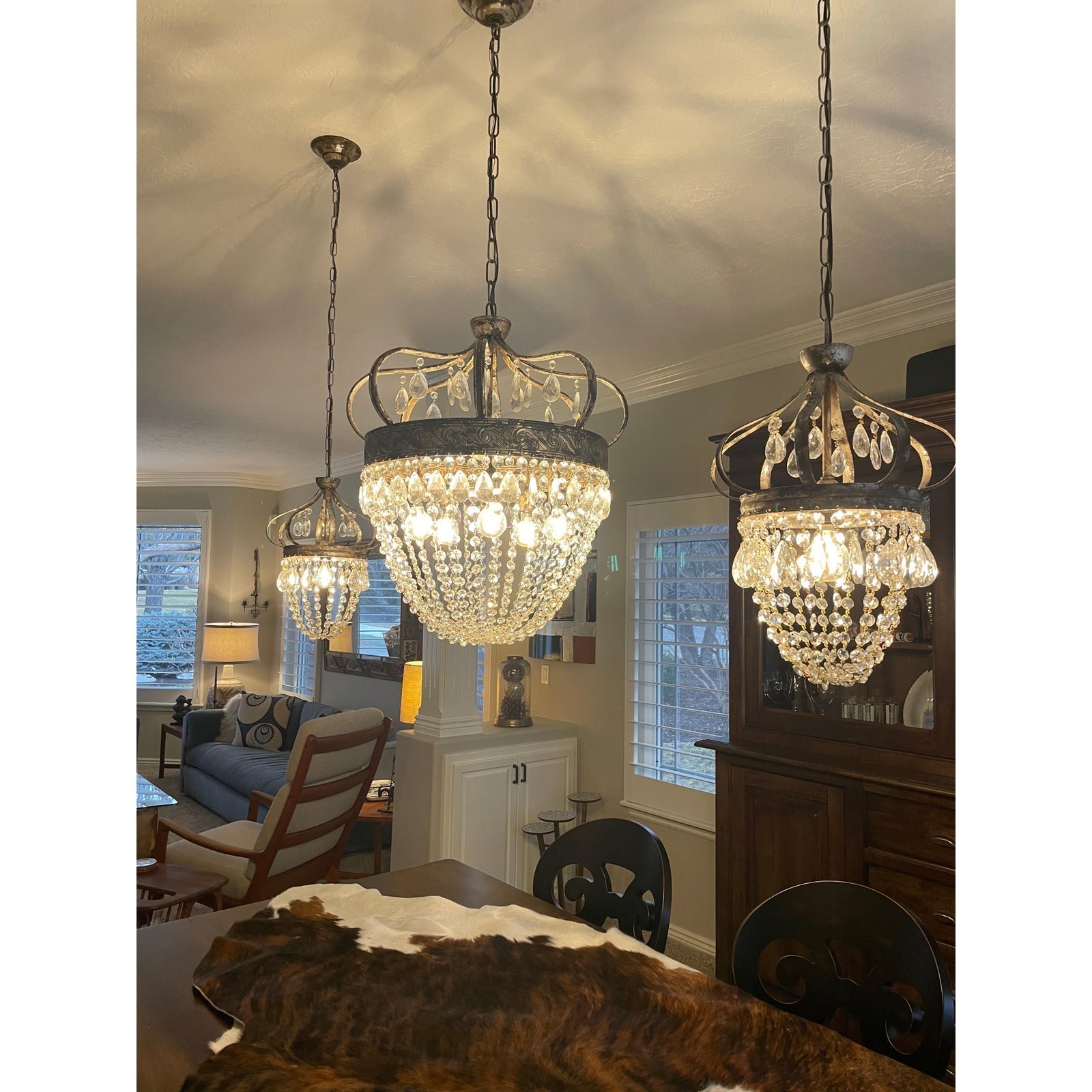 Detail shot of wrought iron crown on Vantara crystal chandelier, antiqued silver