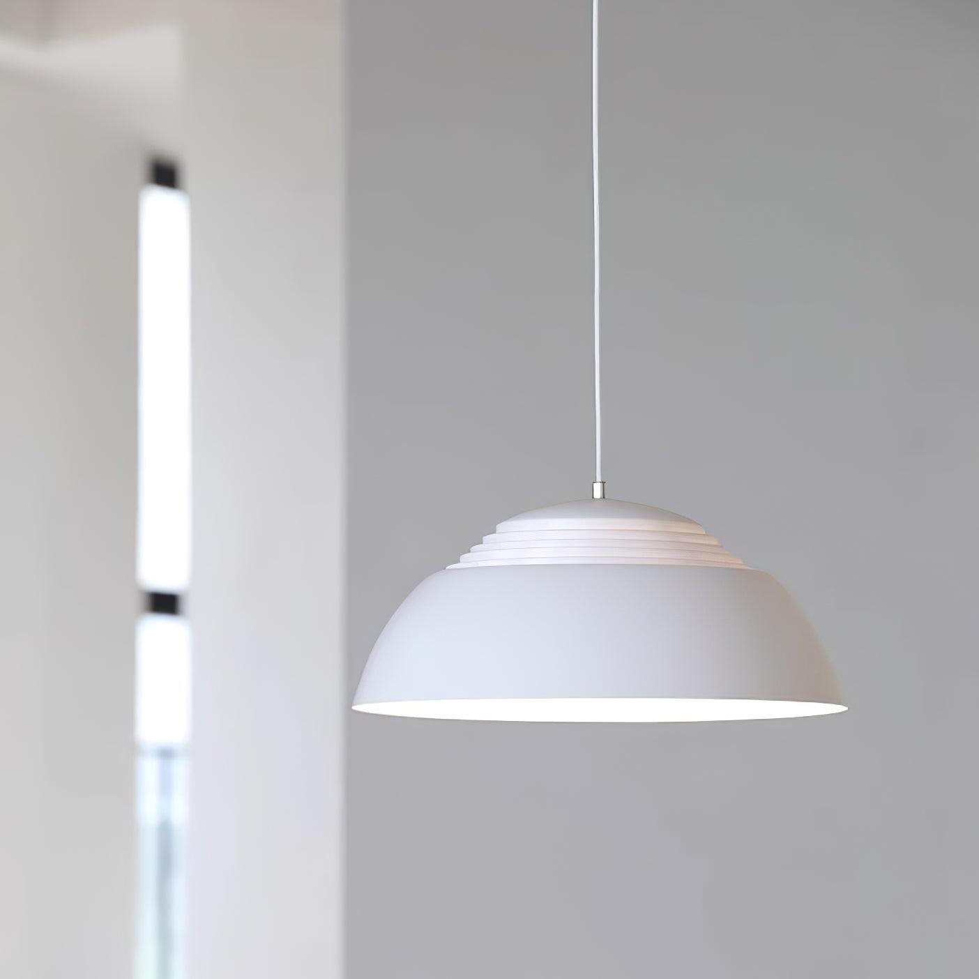 Vantara drum pendant in matte white with warm Edison bulb glow in a modern dining room