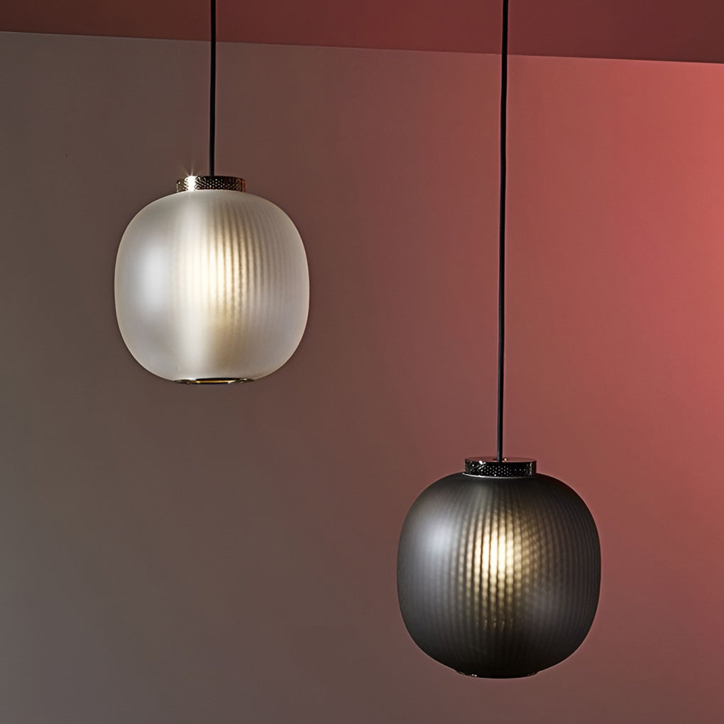 Aureon glass pendant light in white, lit from below showing diffused LED light output