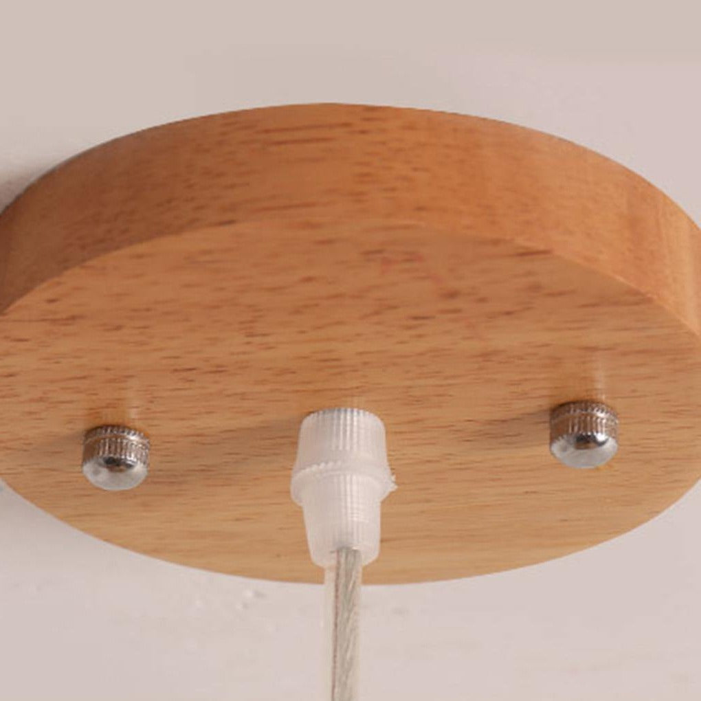 Aureon bamboo pendant light illuminated, warm diffused light in a living room