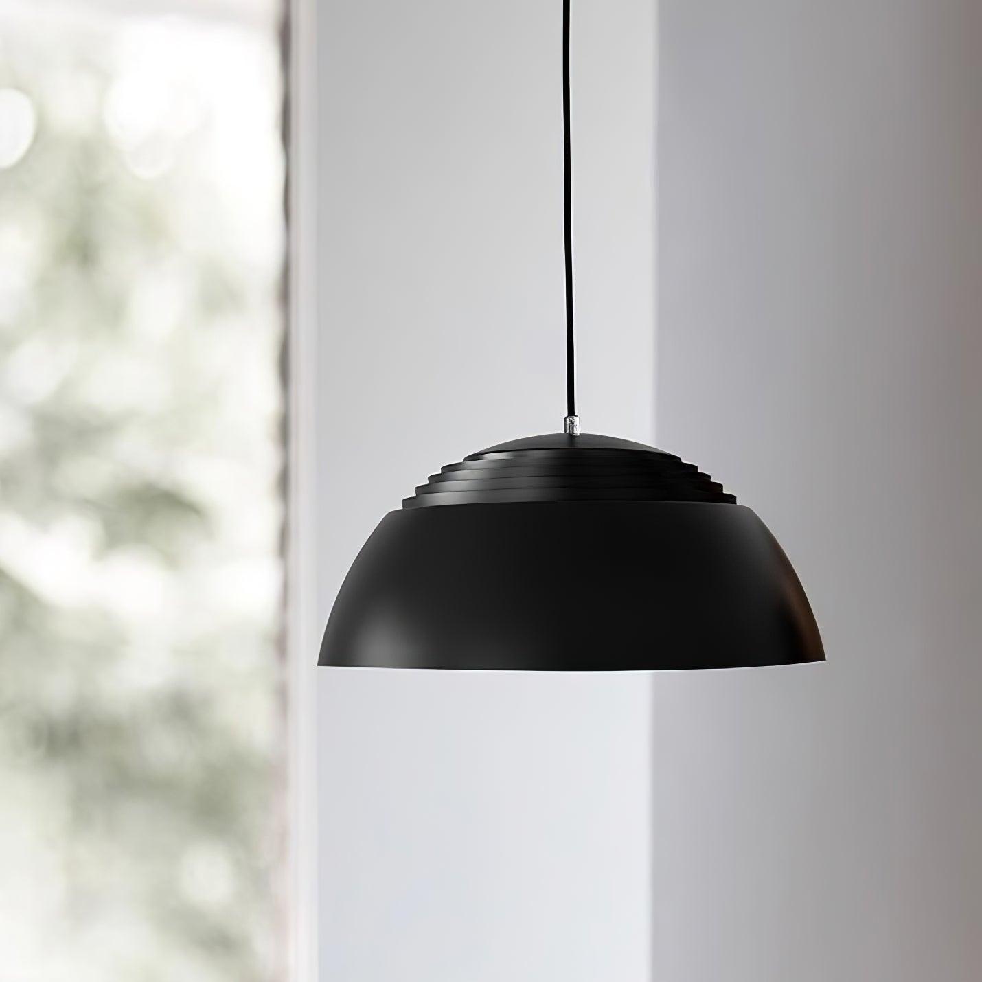 Vantara aluminium ceiling pendant in matte black installed in a hallway with a high ceiling