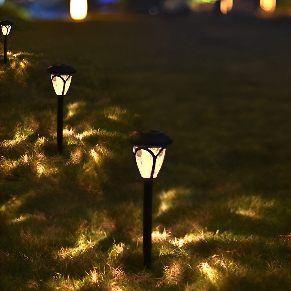 Six Solvara solar stake lights arranged along a garden path at night with ambient warm glow