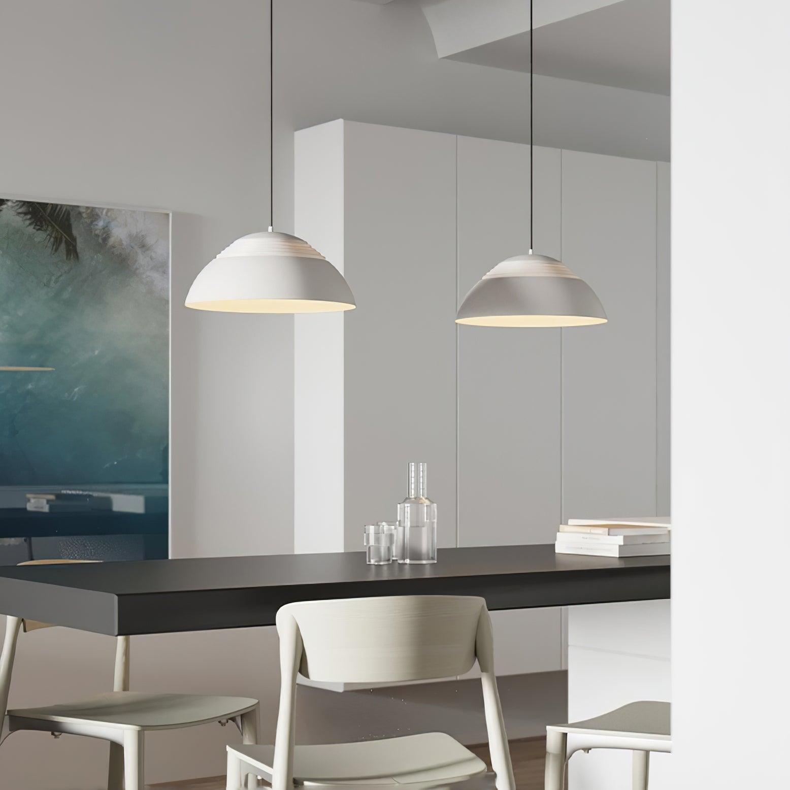 Vantara small aluminium pendant light in matte black above a desk in a modern home office