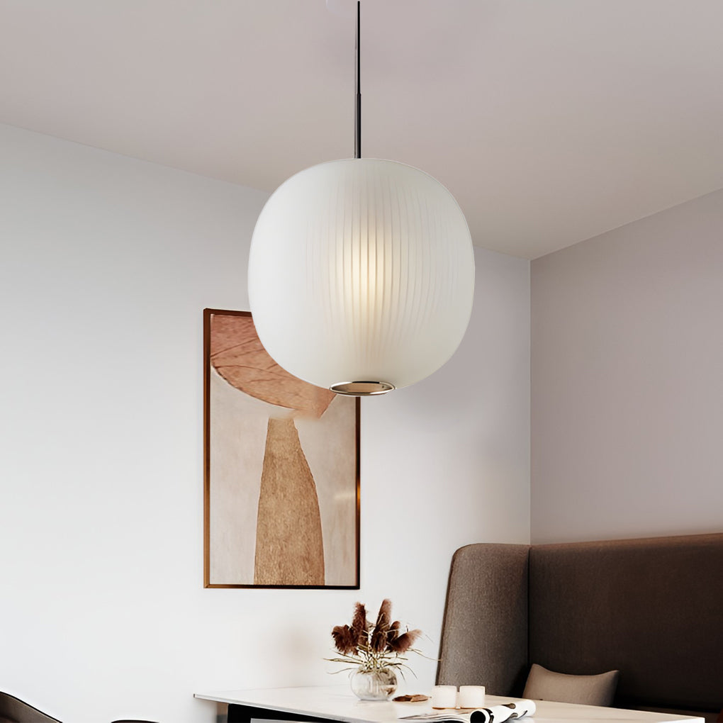 Aureon glass pendant light in white, hanging above a dining table in a contemporary interior