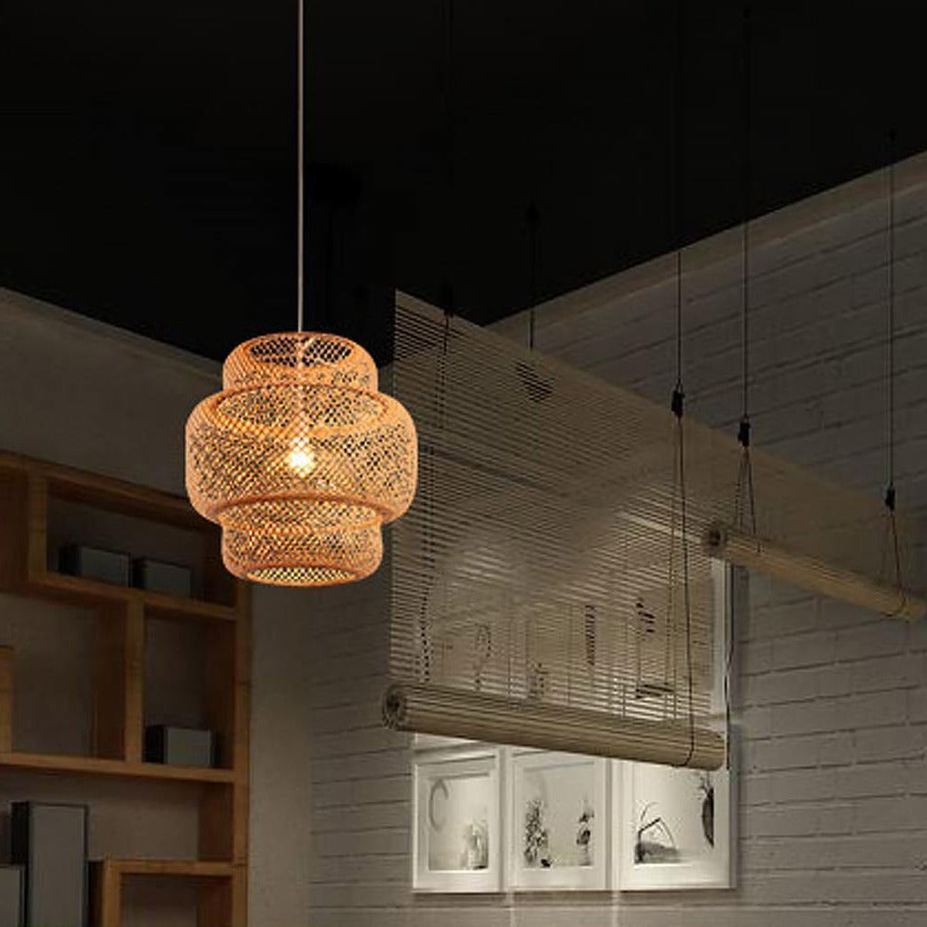 Aureon woven bamboo pendant light suspended above a dining table, side angle