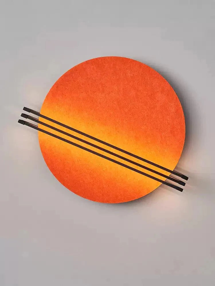 Three colour options of the Vantara felt wall sconce: grey, orange, and blue, displayed side by side