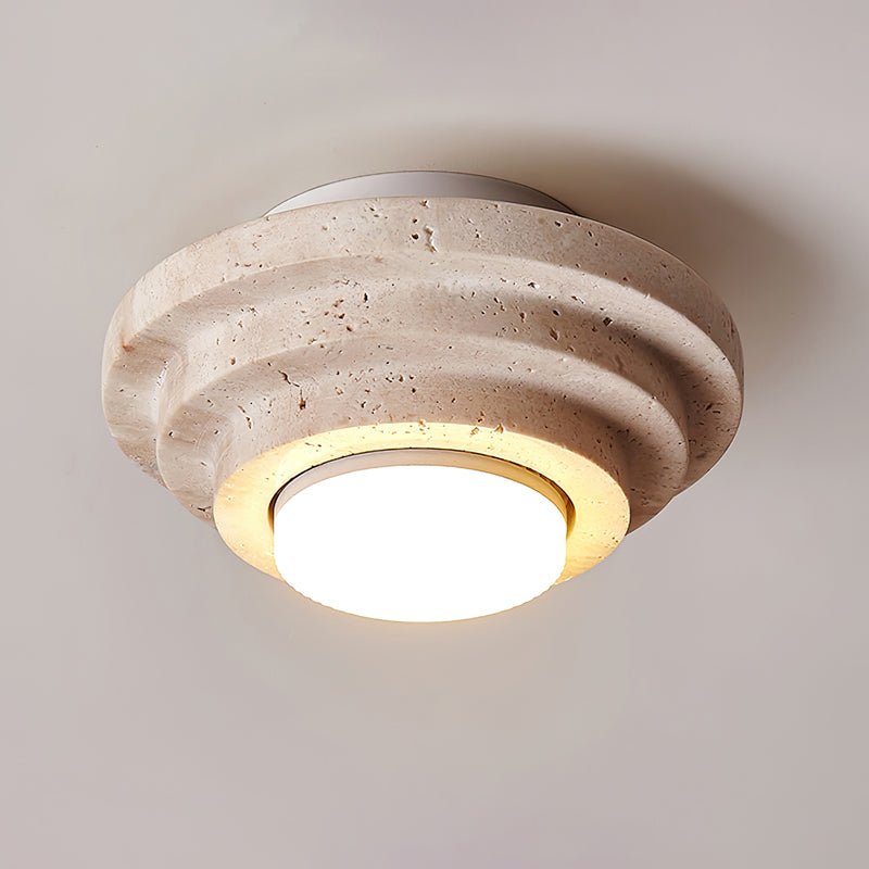 Tana stone ceiling light casting warm amber glow in a calm Wabi-Sabi interior