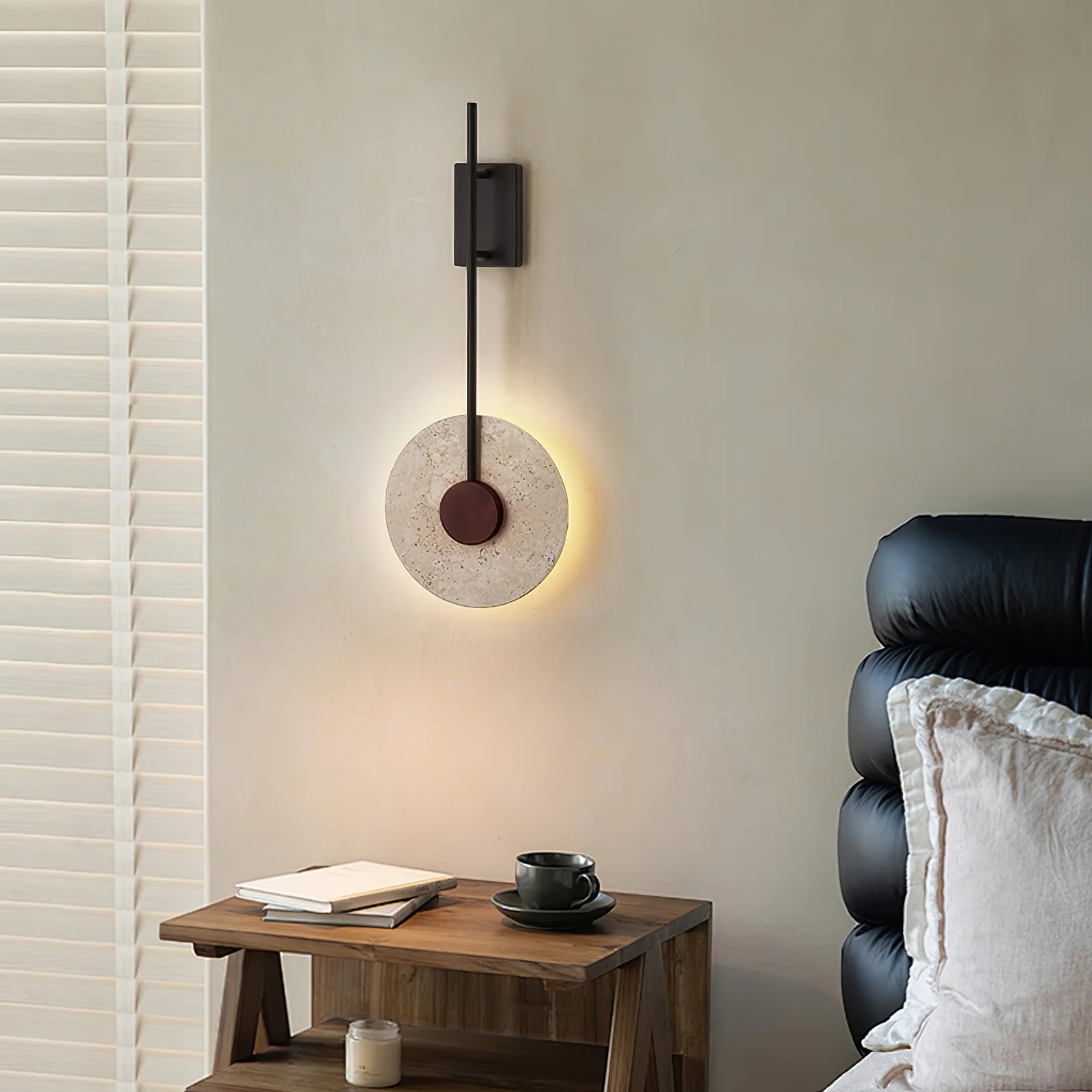 Tovi travertine wall light mounted in a minimal hallway with warm ambient lighting