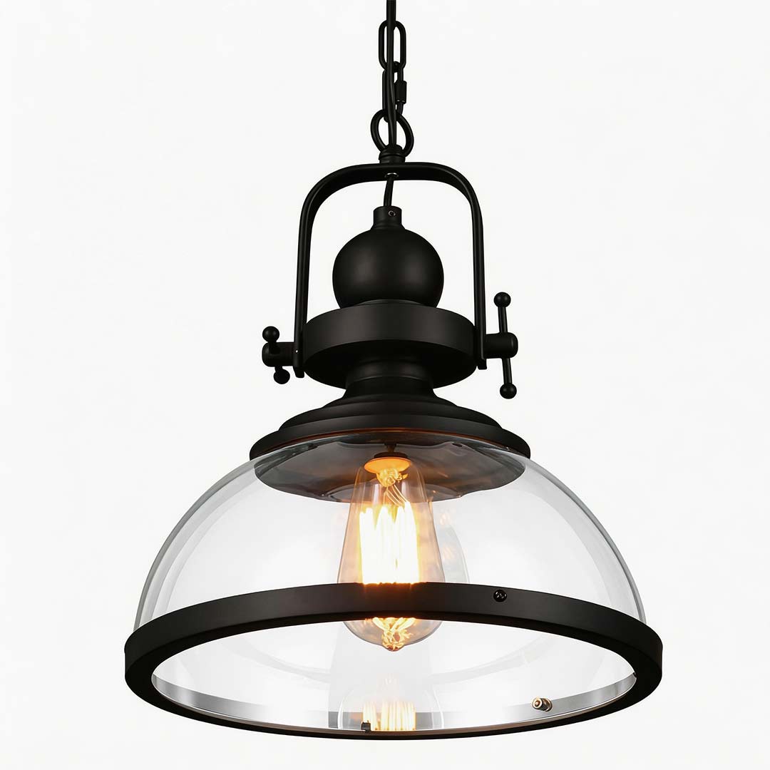 Aureon industrial ceiling pendant light, lit warm glow through clear glass shade
