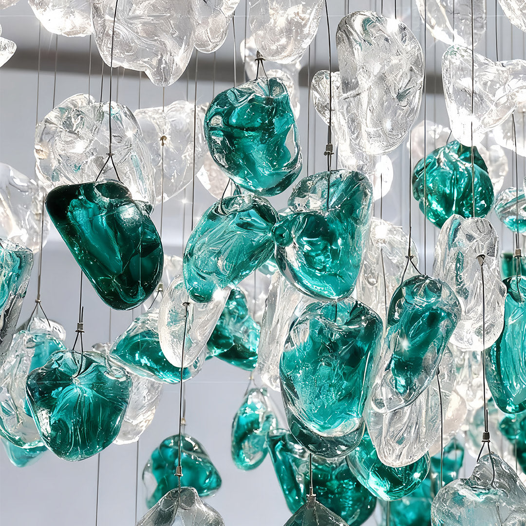 Auréline glass chandelier illuminated, warm light through hand-blown green glass beads