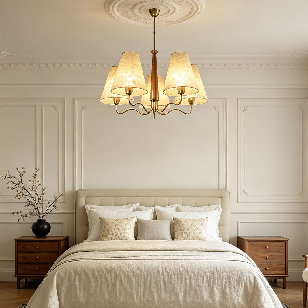 Close-up of Auréline chandelier iron frame and parchment fabric shade detail, warm ambient lighting