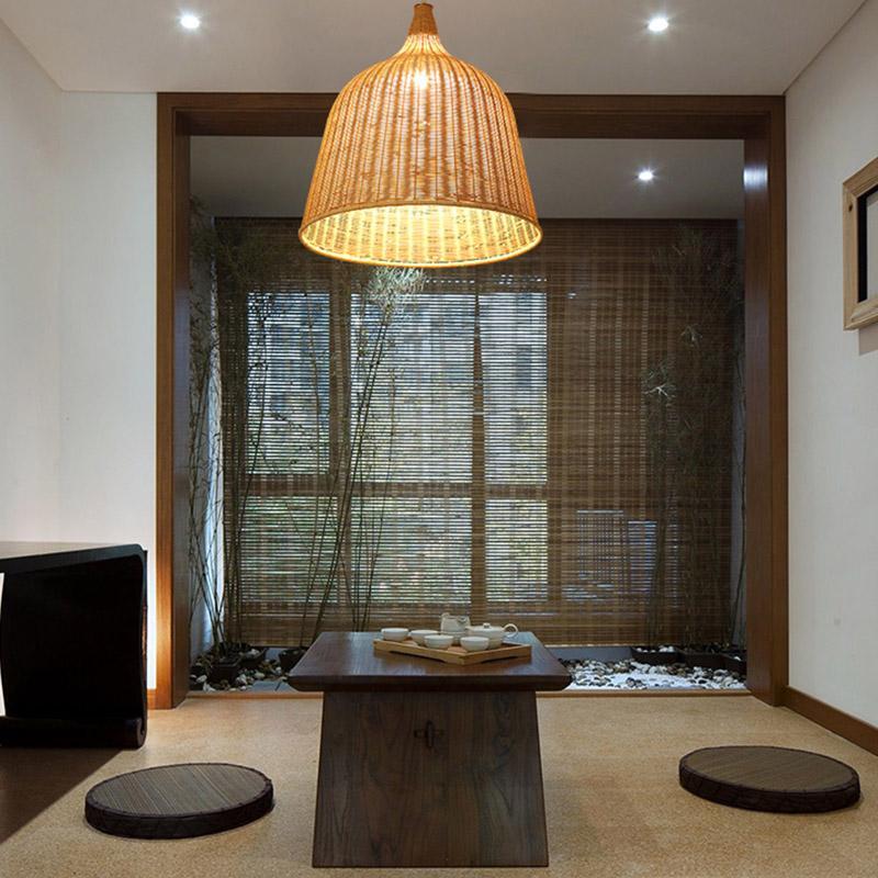Aureon bell-shaped rattan pendant light in natural wood finish, woven shade casting warm ambient light