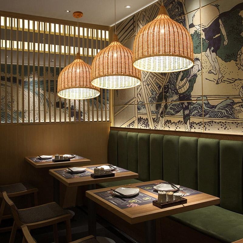 Rattan woven pendant light hanging above a dining table, warm filtered glow through natural shade