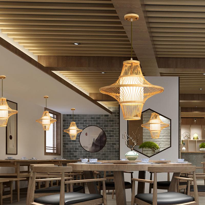 Bamboo pendant light with open-weave shade casting patterned ambient light, side angle view
