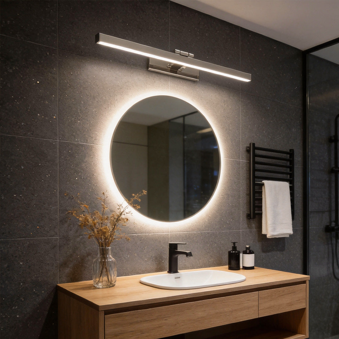 LED vanity light bar in a dark-toned modern bathroom creating even mirror lighting