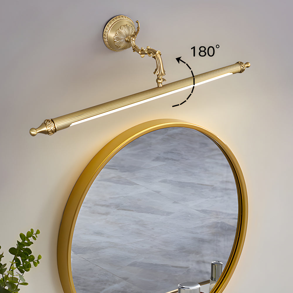 Brushed gold vanity light bar illuminating a frosted glass bathroom mirror