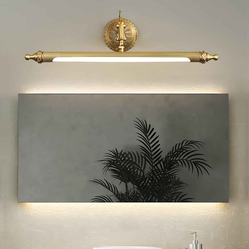 Brushed gold linear vanity light bar above a rectangular bathroom mirror