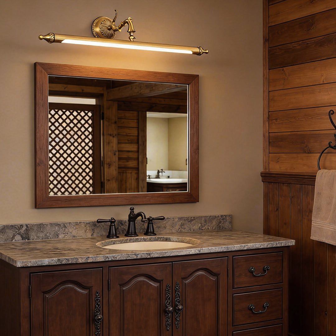 Brushed gold vanity light bar in a warm-toned rustic bathroom setting