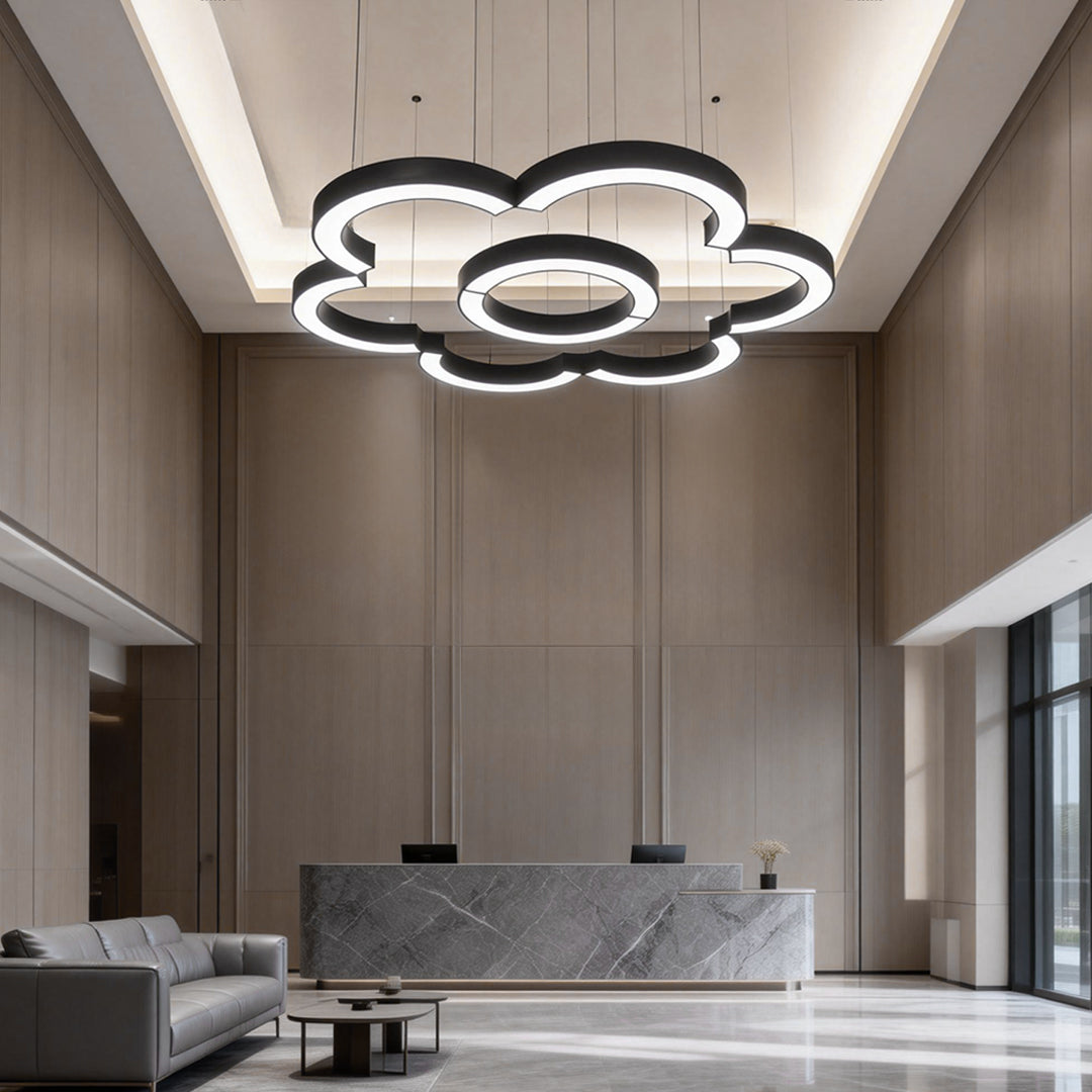 Multiple Aureon C-shape pendant lights installed across a hotel lobby ceiling
