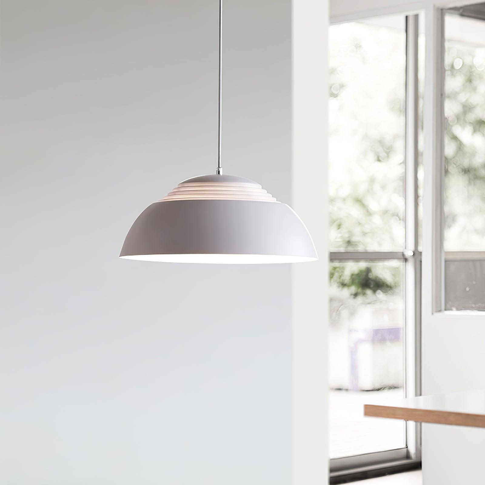 Vantara 50 cm drum pendant light in matte white illuminating a set dining table in a modern interior