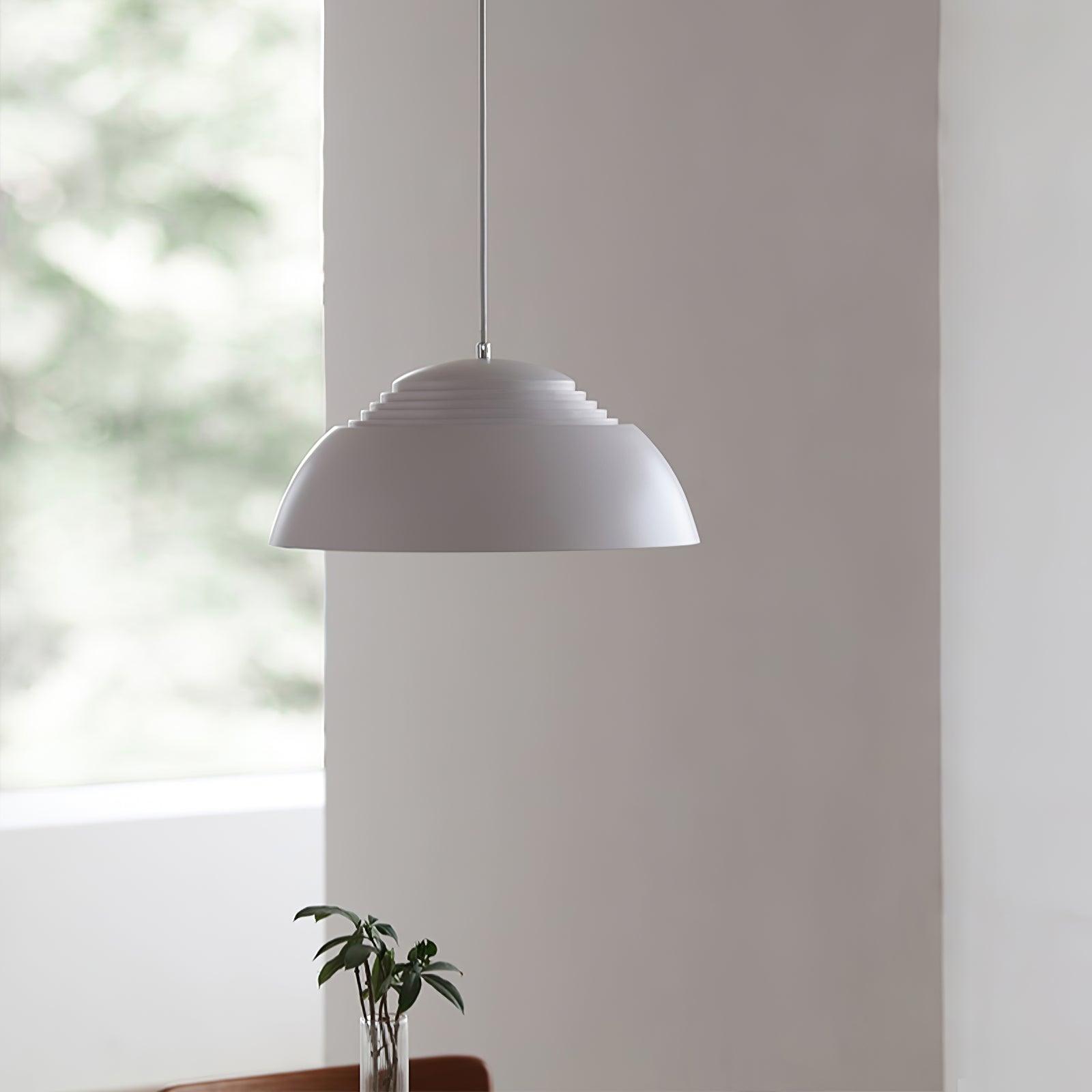 Vantara ridged drum pendant in matte black in an industrial-style interior with exposed brick
