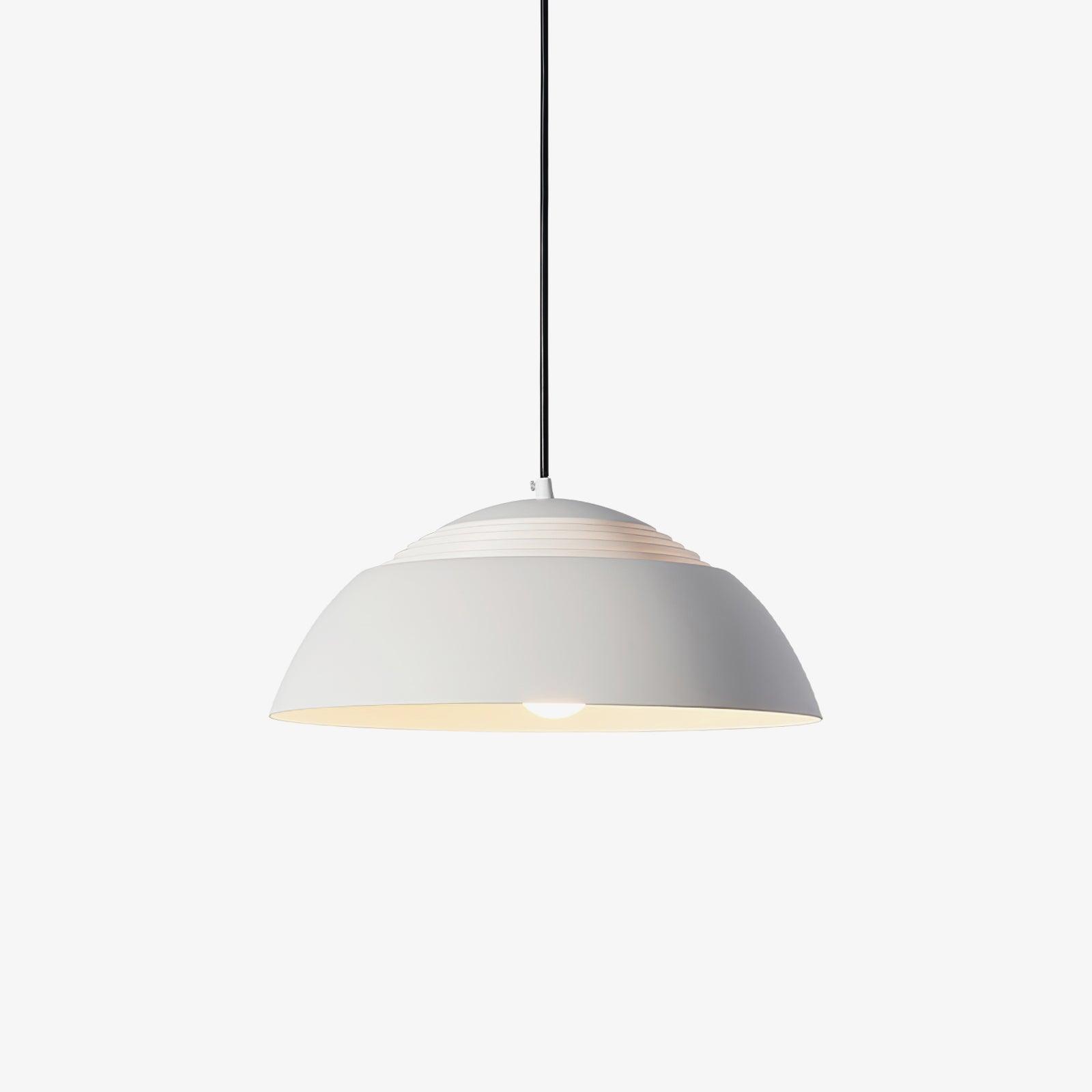 Vantara 50 cm drum pendant light in matte black above a dining table in a modern interior