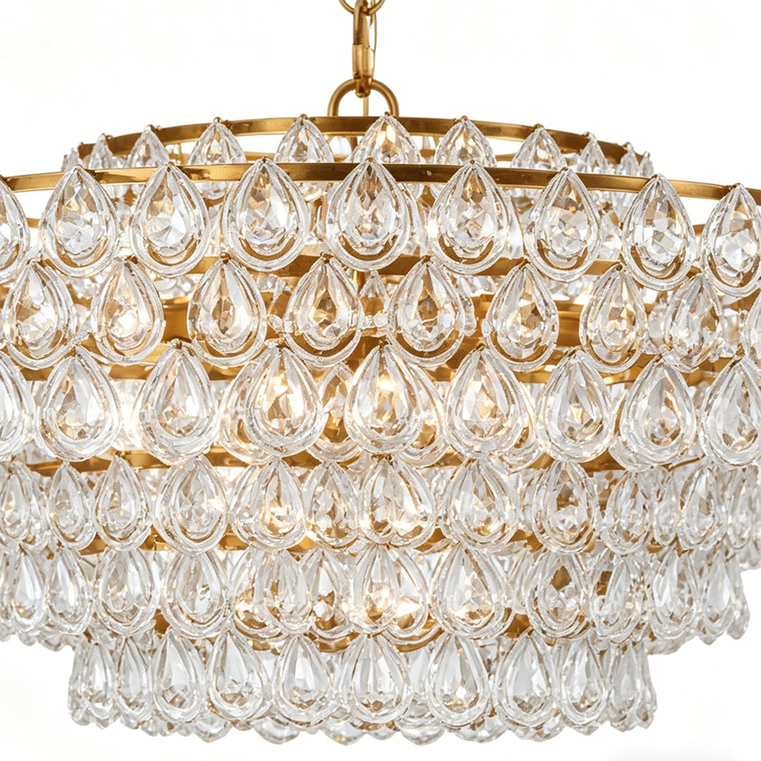 Close-up detail of crystal glass pendants on the Auréline chandelier, copper finish frame