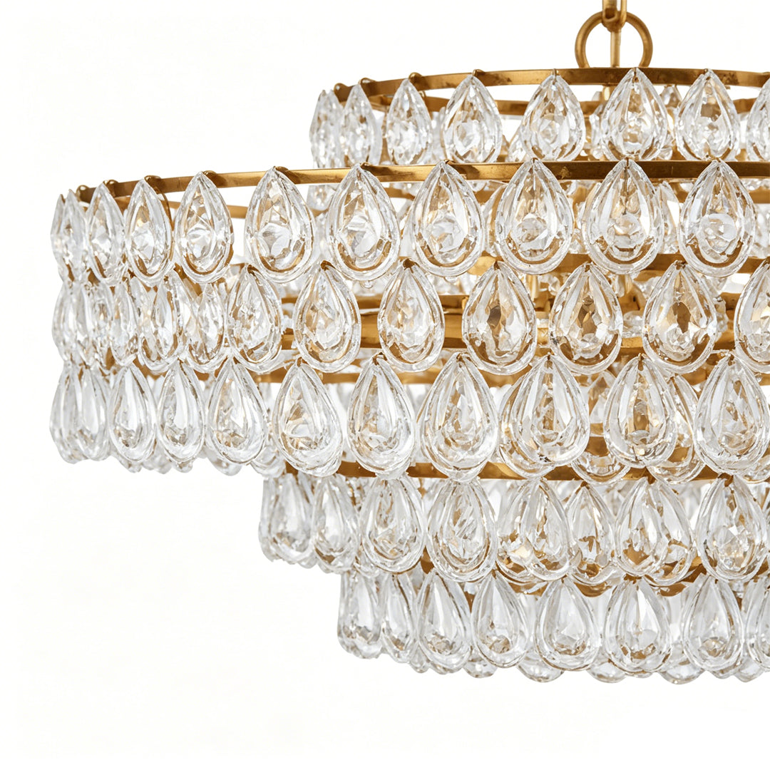 Detail view of crystal glass drops on a modern copper chandelier, warm light reflection