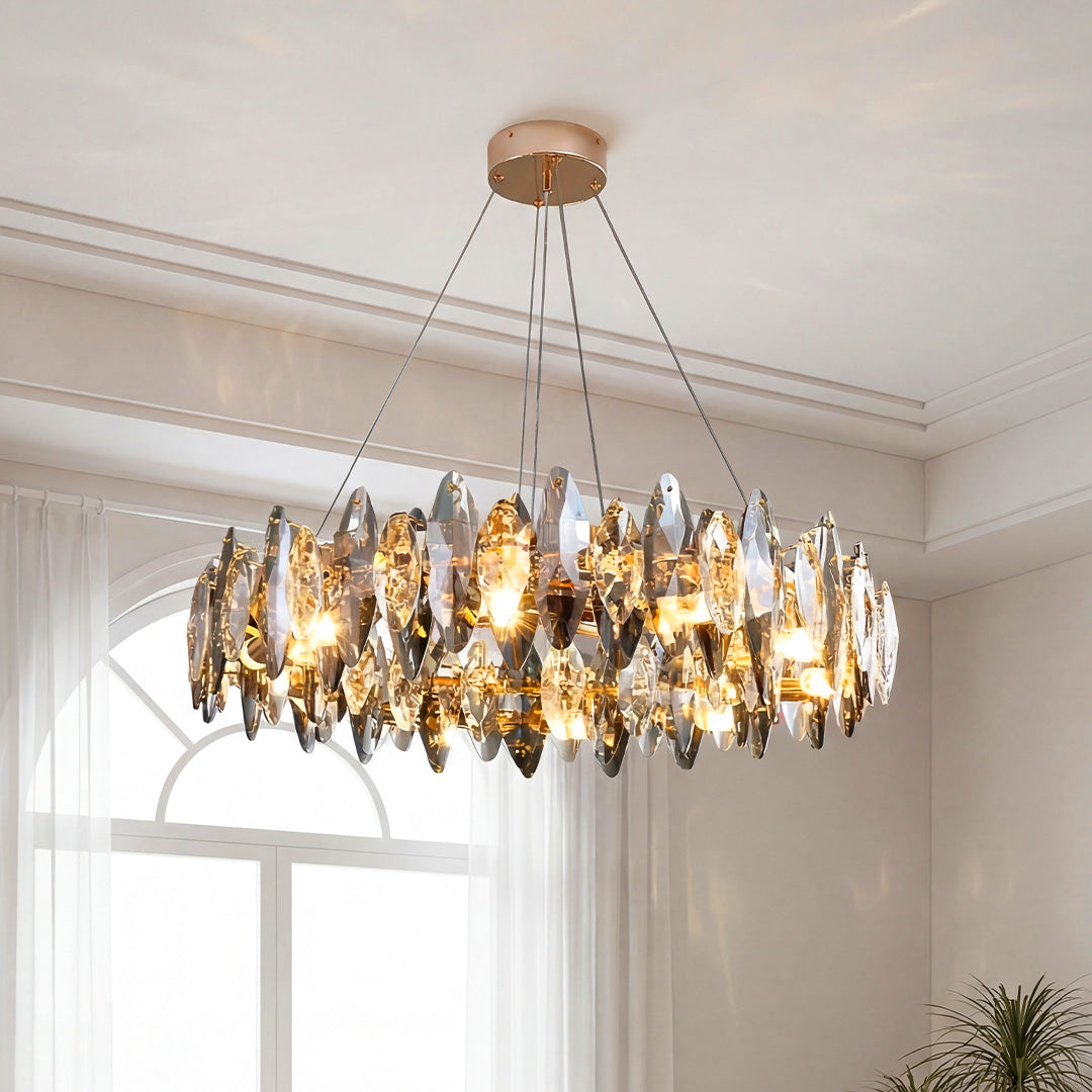 Crystal chandelier with smoky leaf-shaped glass shades illuminated in a bright modern room