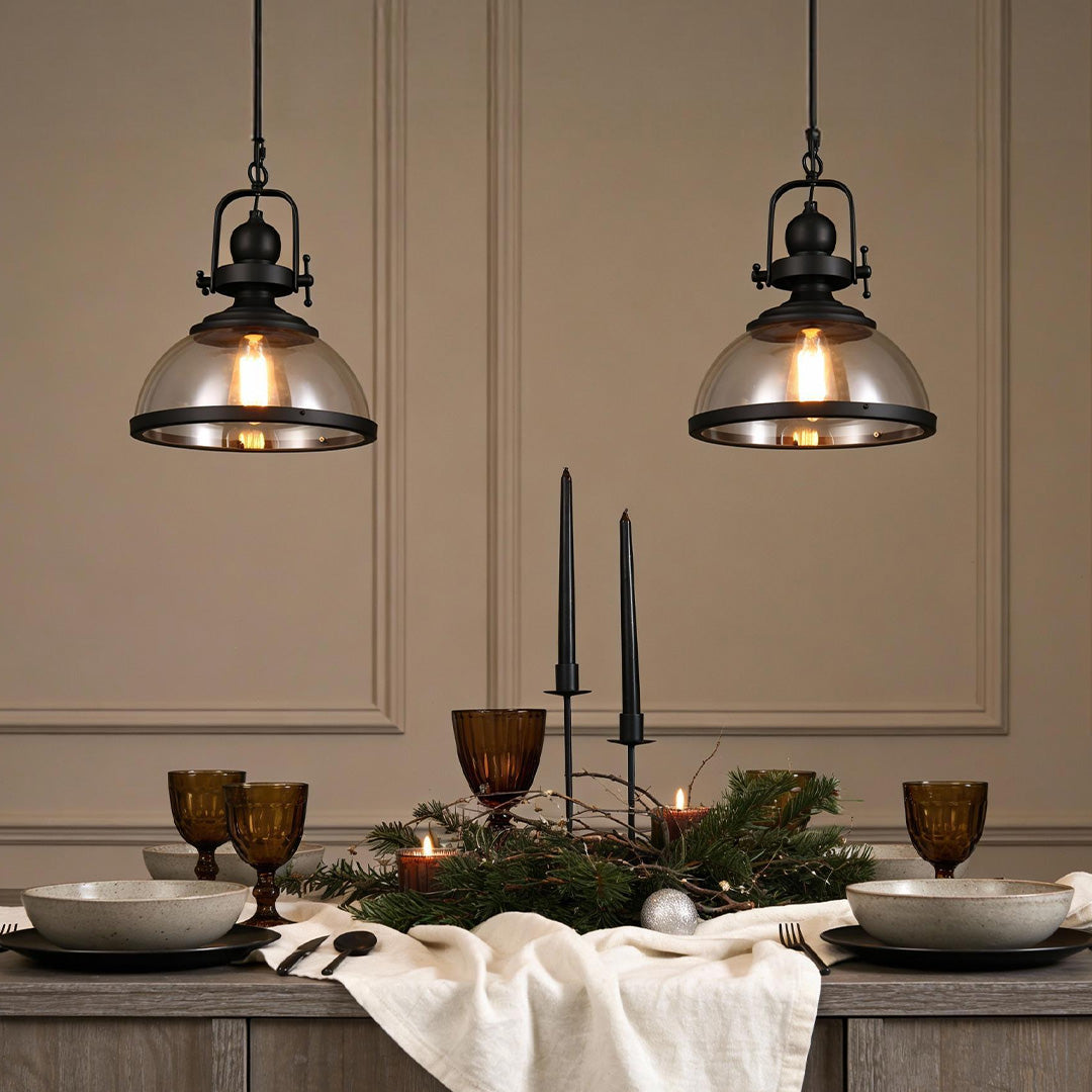 Aureon glass bowl pendant light hanging above a dining table