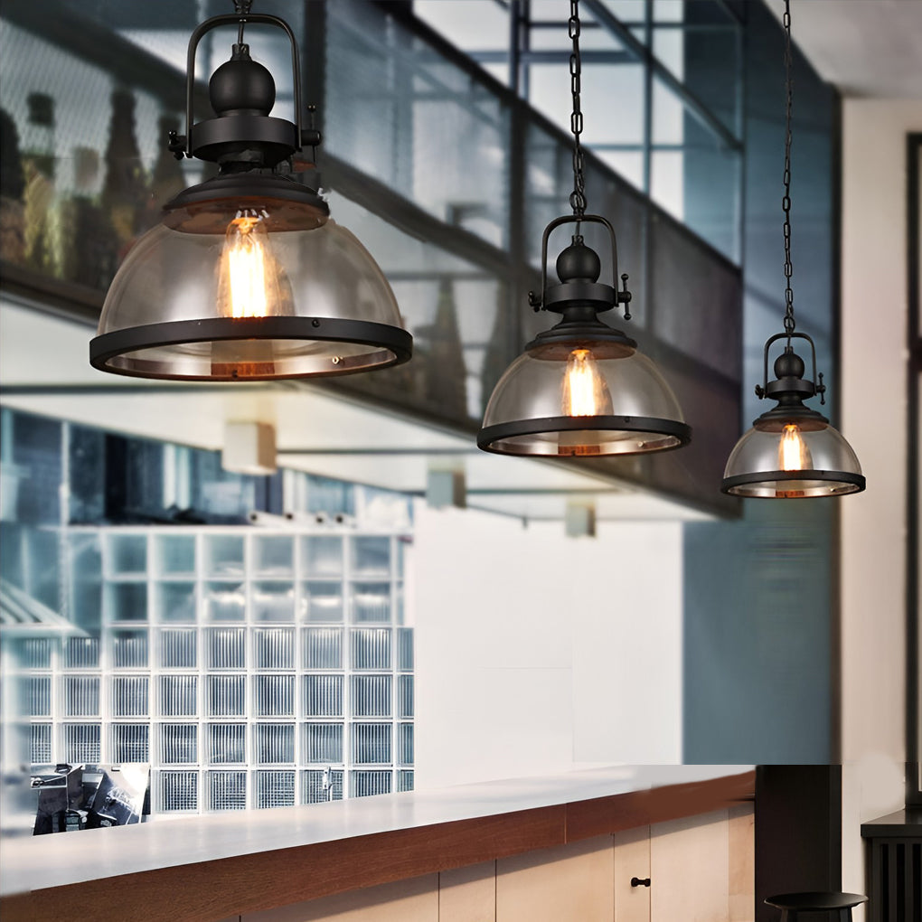 Multiple Aureon glass pendant lights hanging in a row above a kitchen island