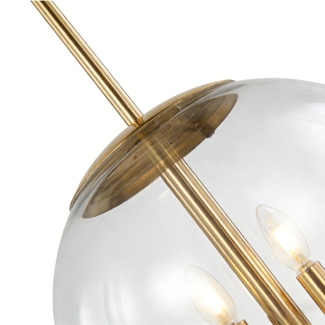 Close-up detail of clear glass globe and gold frame on Aureon pendant light