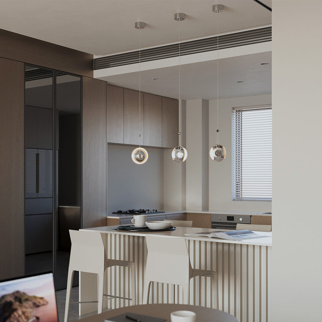 Cluster of Aureon clear crystal pendant lights hanging in a modern staircase void