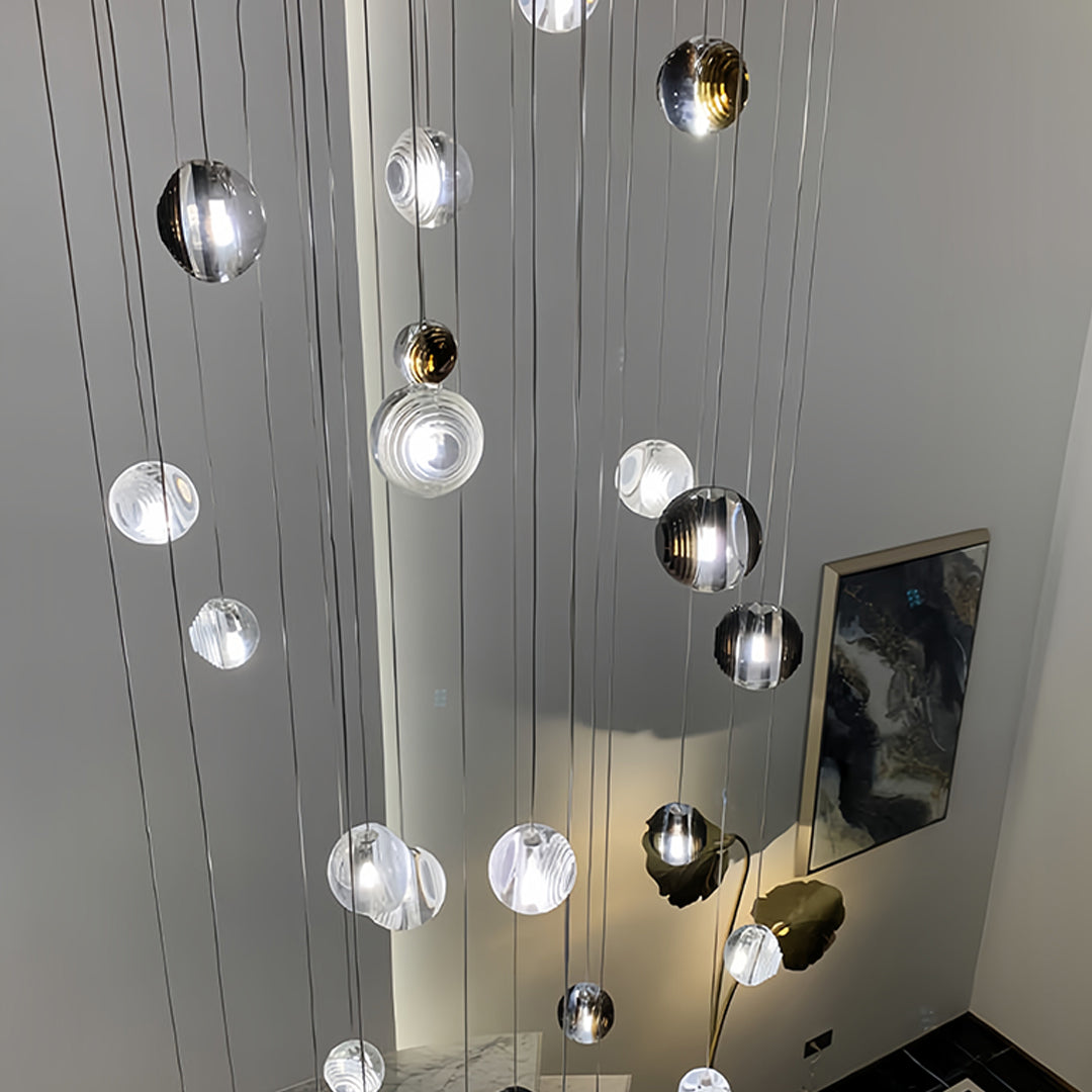Close-up of Aureon smoked glass sphere pendant, sleek reflective metal and glass detail