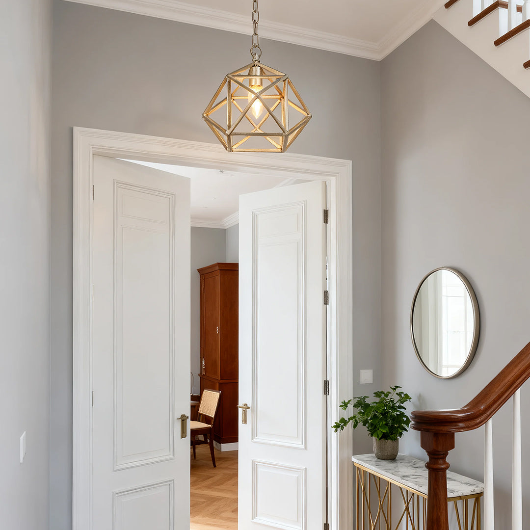 Close-up of Aureon multifaceted brass-frame cage pendant light with clear glass detail