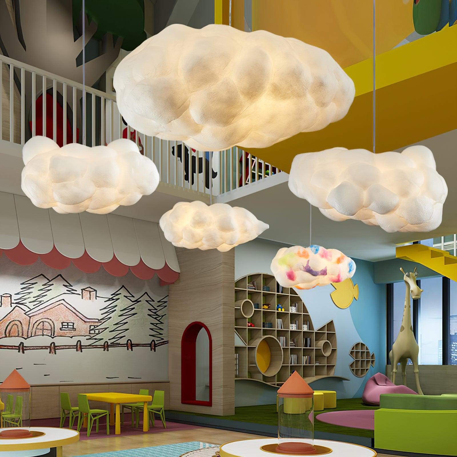 Multiple cloud pendant lights installed in an indoor playground space