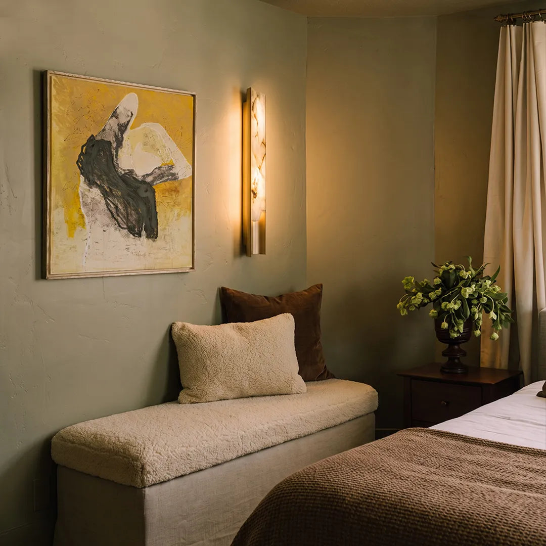 Niva marble wall sconce beside bench seating, contemporary stone wall light indoors