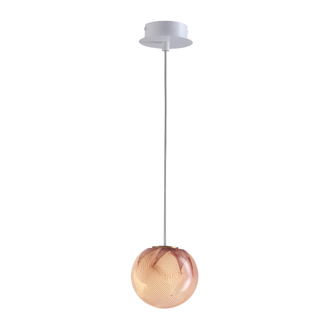 Copper-tinted glass globe pendant light in a modern minimalist room