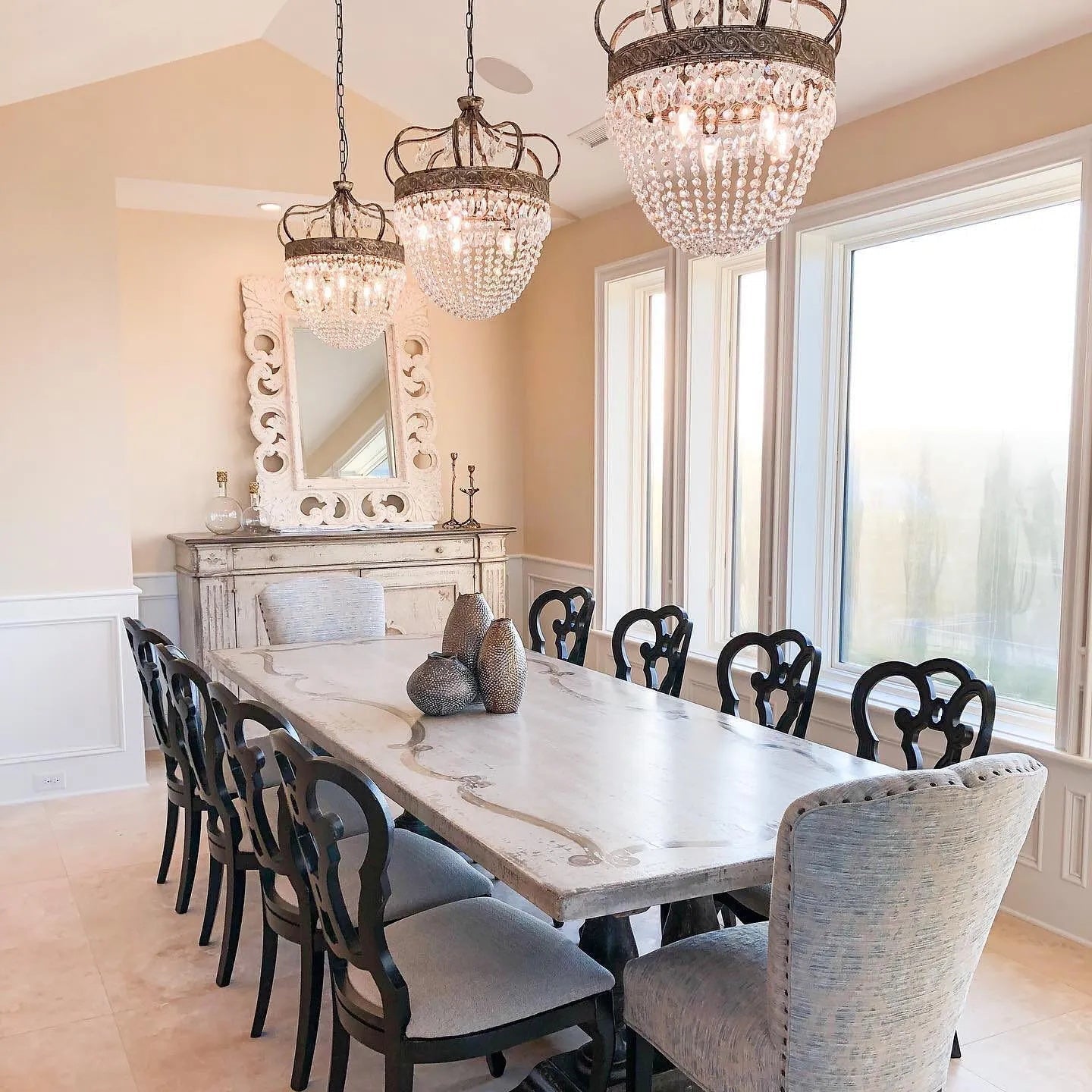 Glass crystal teardrop chandelier hanging in a contemporary dining room interior