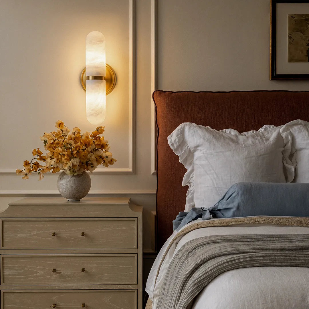 Niva marble wall sconce used as bedside lighting in a contemporary bedroom