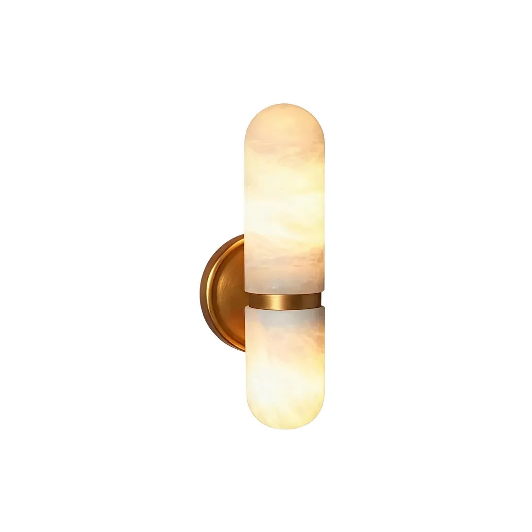 Niva dual marble wall sconce with brass finish showing rounded white marble shades and frosted detail