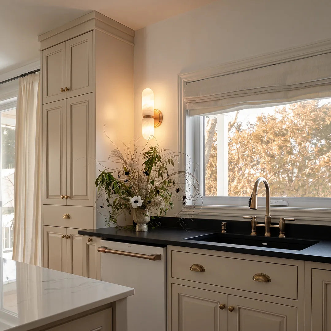 Niva double marble wall sconce providing decorative wall lighting in a modern kitchen