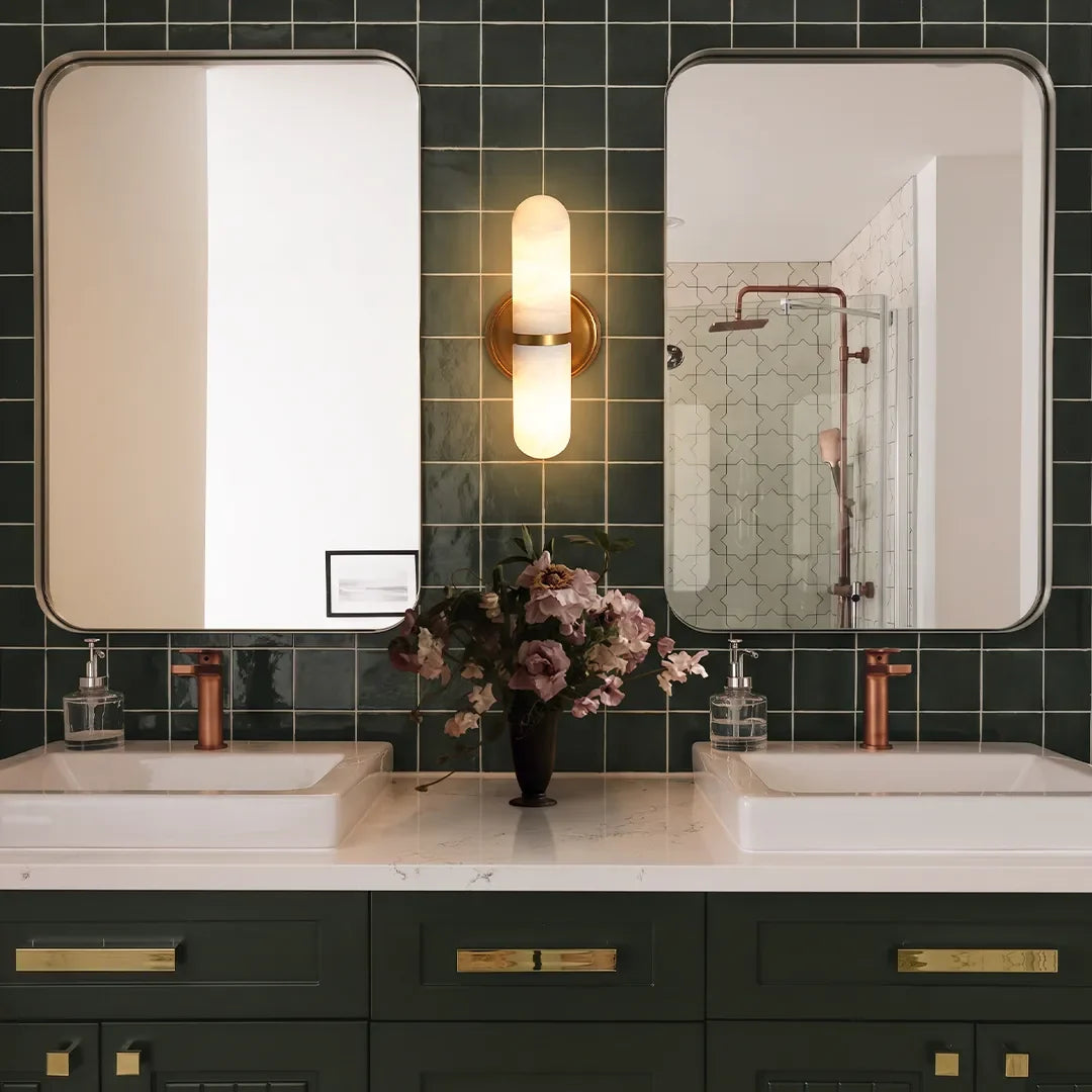 Niva white marble wall sconce with brass connector in a modern bathroom interior