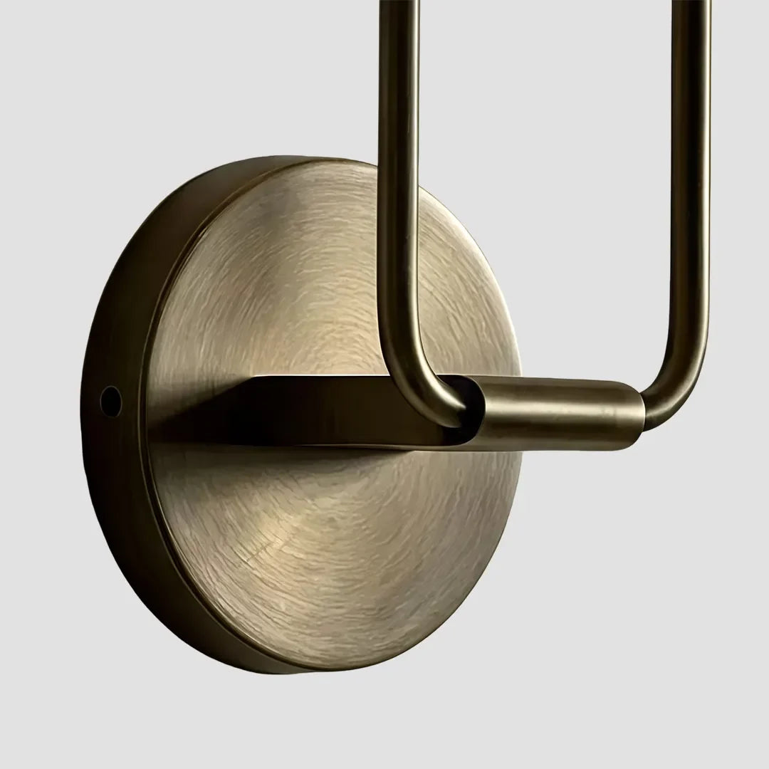 Detail of Niva wall sconce round brass backplate and spherical connector arm joints